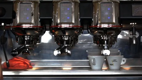 A coffee machine and a man bartender serving customers with coffee cups. Stock Footage 104543005