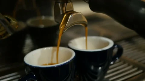 Coffee machine behind the bar - shot of espresso poured into cups Stock Footage 62446556