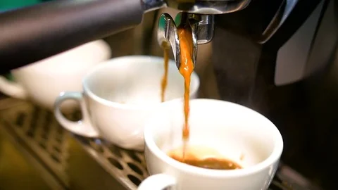 Coffee from a machine being poured into cups Stock Footage 84900105