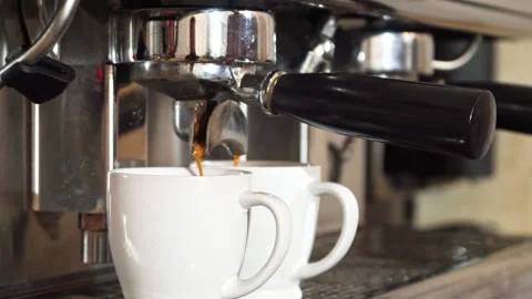 Coffee machine brewing aromatic espresso into two pristine white cups Stock Footage 311941653