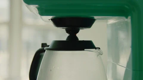 Coffee machine brewing coffee into coffee pot Stock Footage 130089231