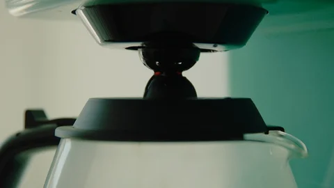 Coffee machine brewing coffee into coffee pot Stock Footage 130089271