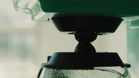 Coffee machine brewing coffee into coffee pot Stock Footage 130089352