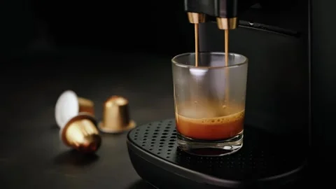 Coffee machine brewing espresso into a glass Stock Footage 285647749