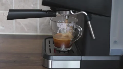 Coffee machine brewing fresh espresso into transparent glass mug Video stock 338175585