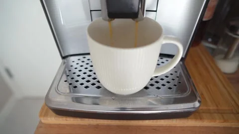 Coffee machine brewing hot fresh coffee. An automatic coffee maker prepares a Stock-Footage 273406413