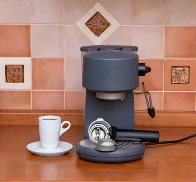 Coffee machine, cup of espresso on table. Coffee Maker in the kitchen interio Stock Photos