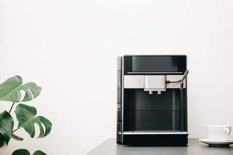 Coffee machine on the desk in the office, clean interior with coffe maker, .. Stock Photos