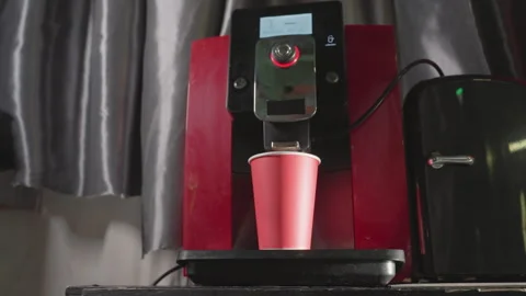 Coffee machine dispensing espresso into red paper cup close-up Video stock 317189928