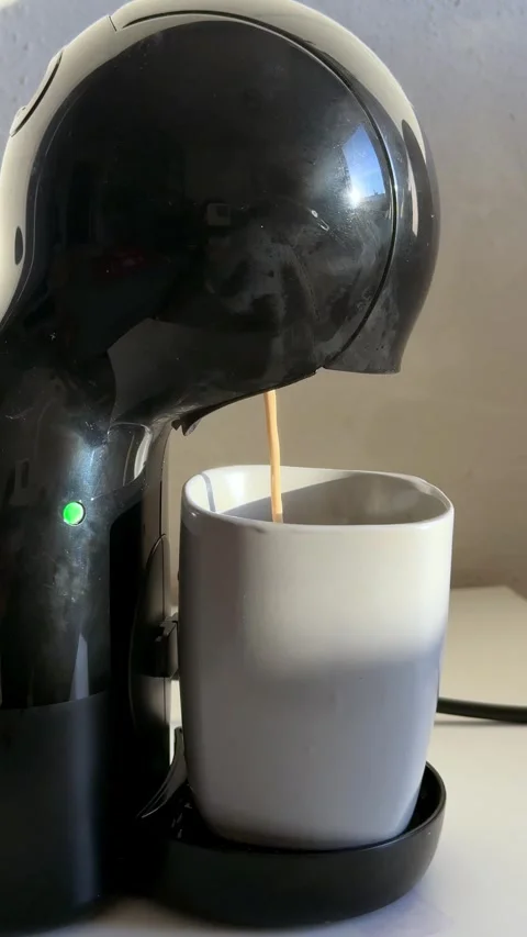 Coffee machine, dispensing warm brown liquid, pouring fresh beverage into Stock Footage 333456580