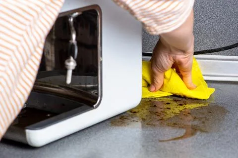 The coffee machine has broken down and needs to be repaired. The woman wipes  Stock Photos