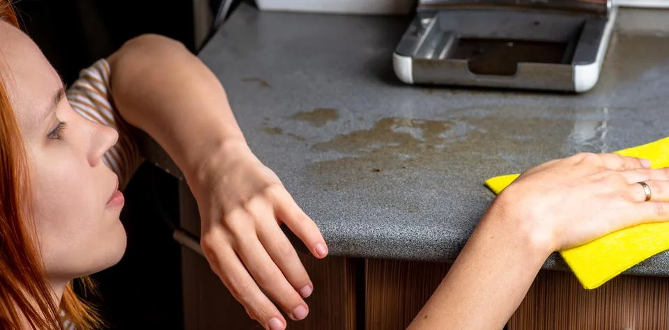 The coffee machine has broken down and needs to be repaired. The woman wipes  Stock Photos