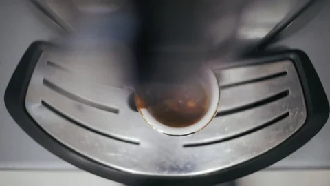 Coffee machine makes coffee in a white cup.coffee pours out of the cup Stock Footage 101181604