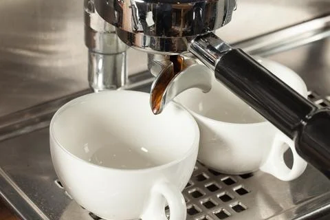 Coffee machine makes two coffee, selective focus Stock Photos