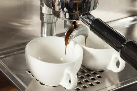 Coffee machine makes two coffee, selective focus Stock Photos