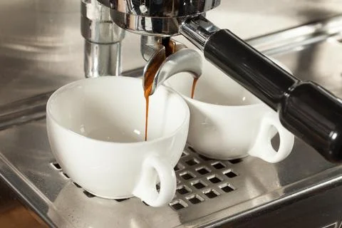 Coffee machine makes two coffee, selective focus Stock Photos