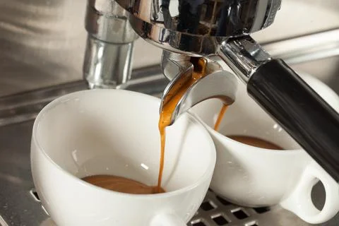 Coffee machine makes two coffee, selective focus Stock Photos