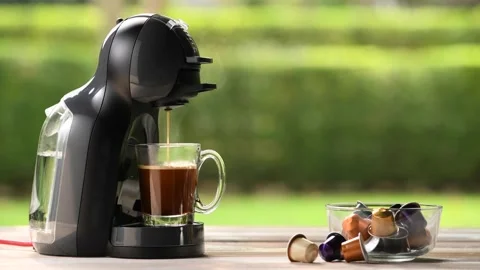 Coffee machine making coffee with capsules on wooden table Stock Footage 147240516