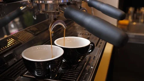 Coffee machine making espresso in two cups in cafe bistro Stock Footage 84830017
