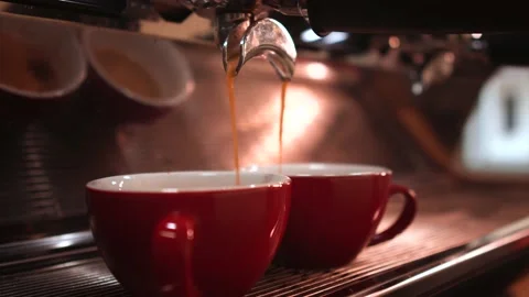 Coffee machine making espresso in two red cups in cafe bistro. Stock Footage 147103427