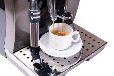 Coffee machine making fresh coffee with visible steam over cup close up Stock Photos