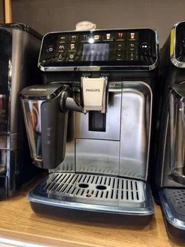 Coffee machine of Philips brand positioned on shelf in electronics retail m.. Stock Photos
