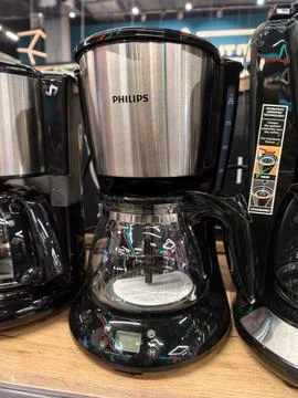 Coffee machine of Philips brand visible on shelf in electronics outlet with.. Stock Photos