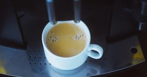 Coffee machine pouring black coffee into white cup. Coffee maker at work.  Stock Footage 122298373