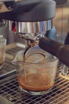 Coffee machine is pouring coffee Stock Photos