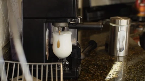 Coffee machine pouring coffee trickle into the glass. Latte Stock Footage 103974470