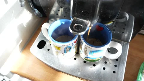 Coffee machine pouring coffee into two mugs Stock Footage 228648495