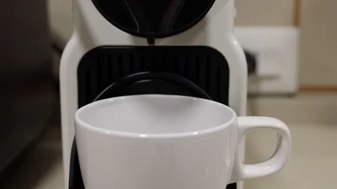 Coffee machine pouring coffee into a white mug Stock Footage 127381566