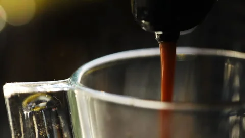 Coffee machine pouring espresso coffee into glass cup Stock Footage 312403078