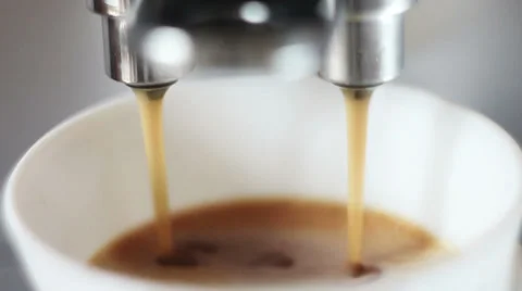 Coffee machine pouring espresso in cup extremely close-up Stock Footage