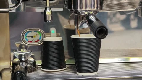 Coffee machine pouring espresso in disposable cup Vidéo 310307242
