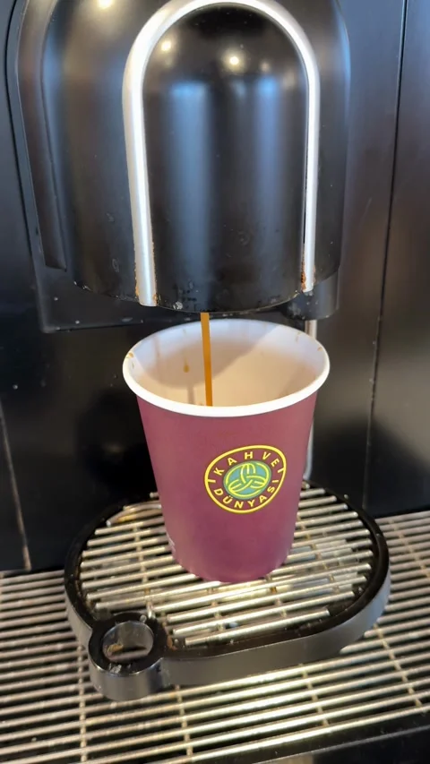 Coffee machine pouring espresso into disposable cup at coffee lounge backgrou Stock Footage 336399568