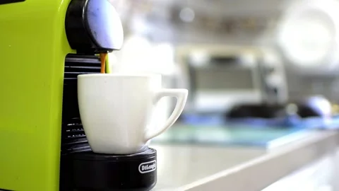 Coffee machine pouring liquid slowly  in a cup at home 動画素材 134490899