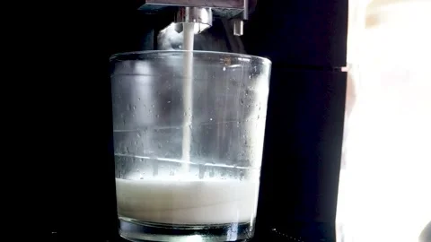 Coffee machine pouring milk for making latte Stock Footage 143933762