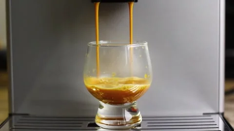 Coffee machine pours coffee into a glass glass Stock Footage 258948982