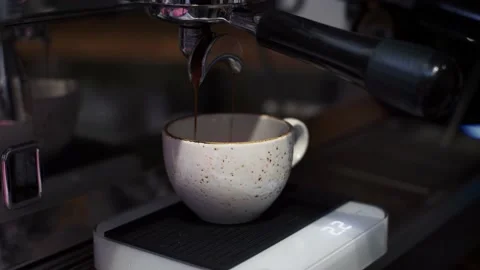 The coffee machine pours coffee into a mug on the scales. Video stock 165000969