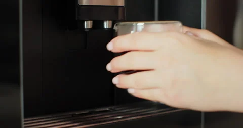 Coffee machine pours coffee into mug. Woman takes the finished drink. Drinking Stock Footage 252755222