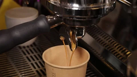The coffee machine pours coffee into a paper cup. coffee to go, takeaway Stock Footage 231627133