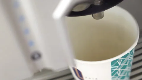The coffee machine pours coffee into a paper cup Stock Footage 248375827