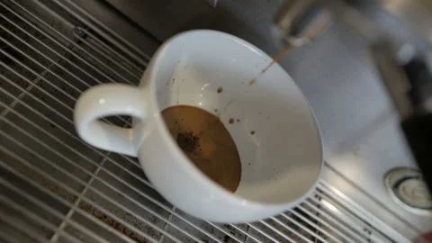 Coffee machine pours coffee into a white cup in a cafe, slow motion Stock Footage 108589969
