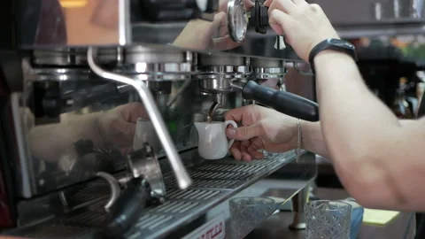Coffee machine pours coffee into a white cup in a cafe, slow motion Stock Footage 111361920