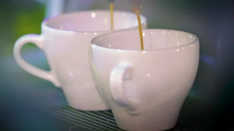 The coffee machine pours coffee into white cups. Fresh espresso. Stock Footage 229567104