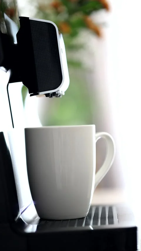 Coffee machine pours coffee into white mug,morning home routine.close up view.4k Stock Footage 279064003
