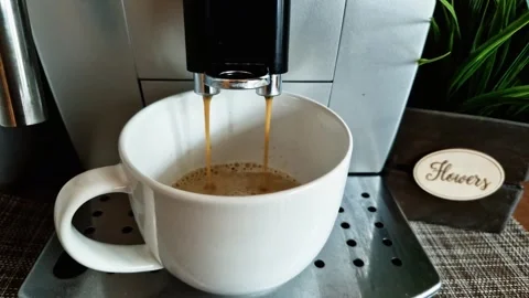Coffee machine pours a rich stream into the cup, capturing the essence of coffee Stock-Footage 263468705
