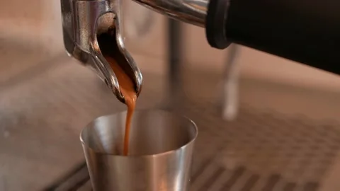 Coffee machine prepares espresso and pours it into metal cup. Video stock 197066351