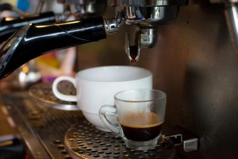 Coffee machine preparing fresh coffee and pouring  in cup Stock Photos